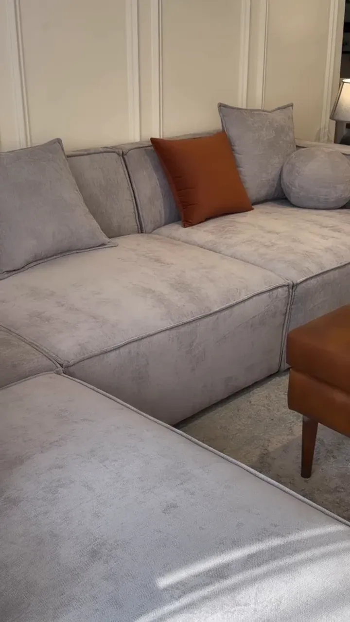 Close view of the BADAL sofa corner seat and scatter cushions in grey textured fabric