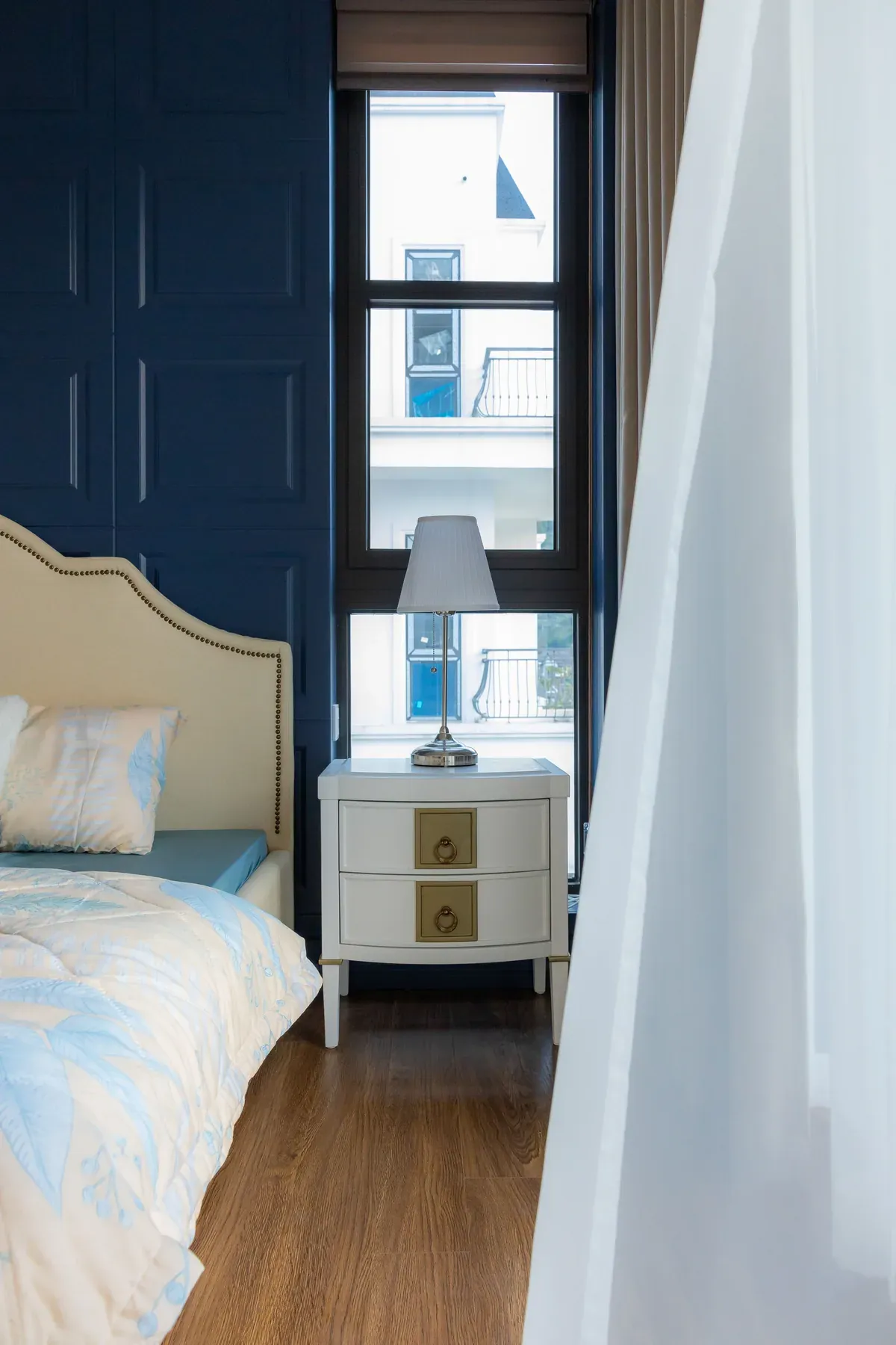 Cream wingback bed with a matching bedside table — reference image for the SHAB wingback upholstered bed