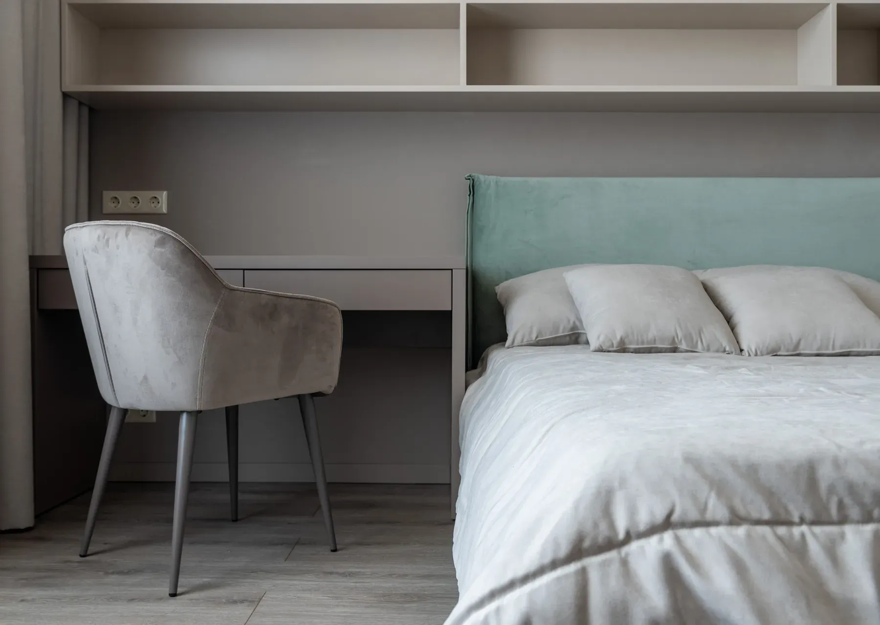 Grey upholstered bed beside a built-in study desk — reference image for the ARAAM panelled upholstered bed