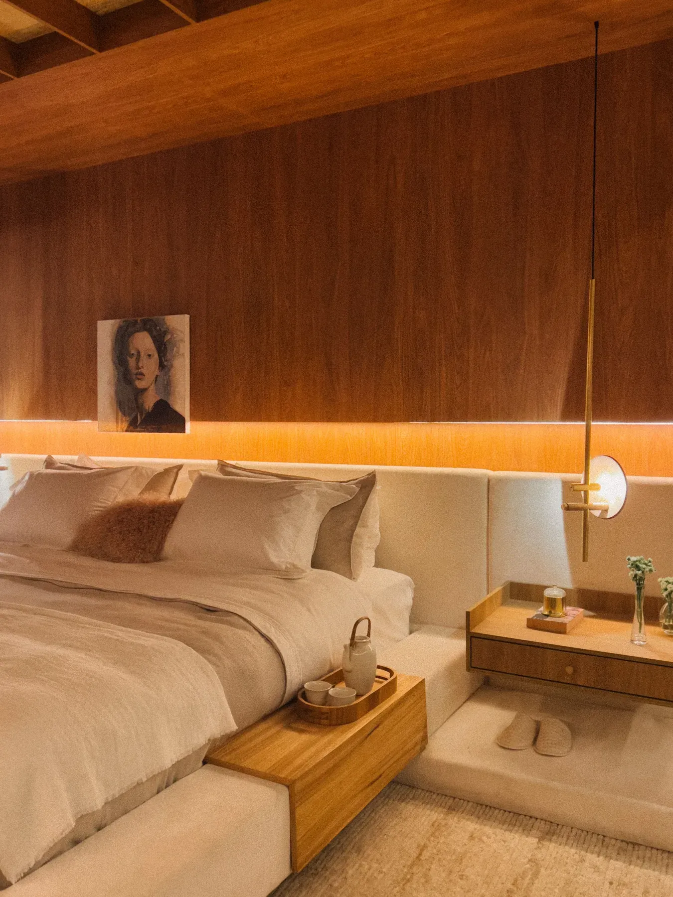 Cream upholstered bed with warm timber wall panels — reference image for the SUKHAN channelled headboard bed