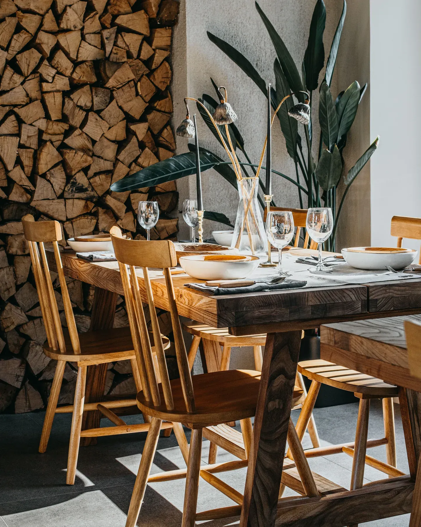 Rustic wood dining table with matching spindle chairs — reference image for the NEMAT plank-top dining set