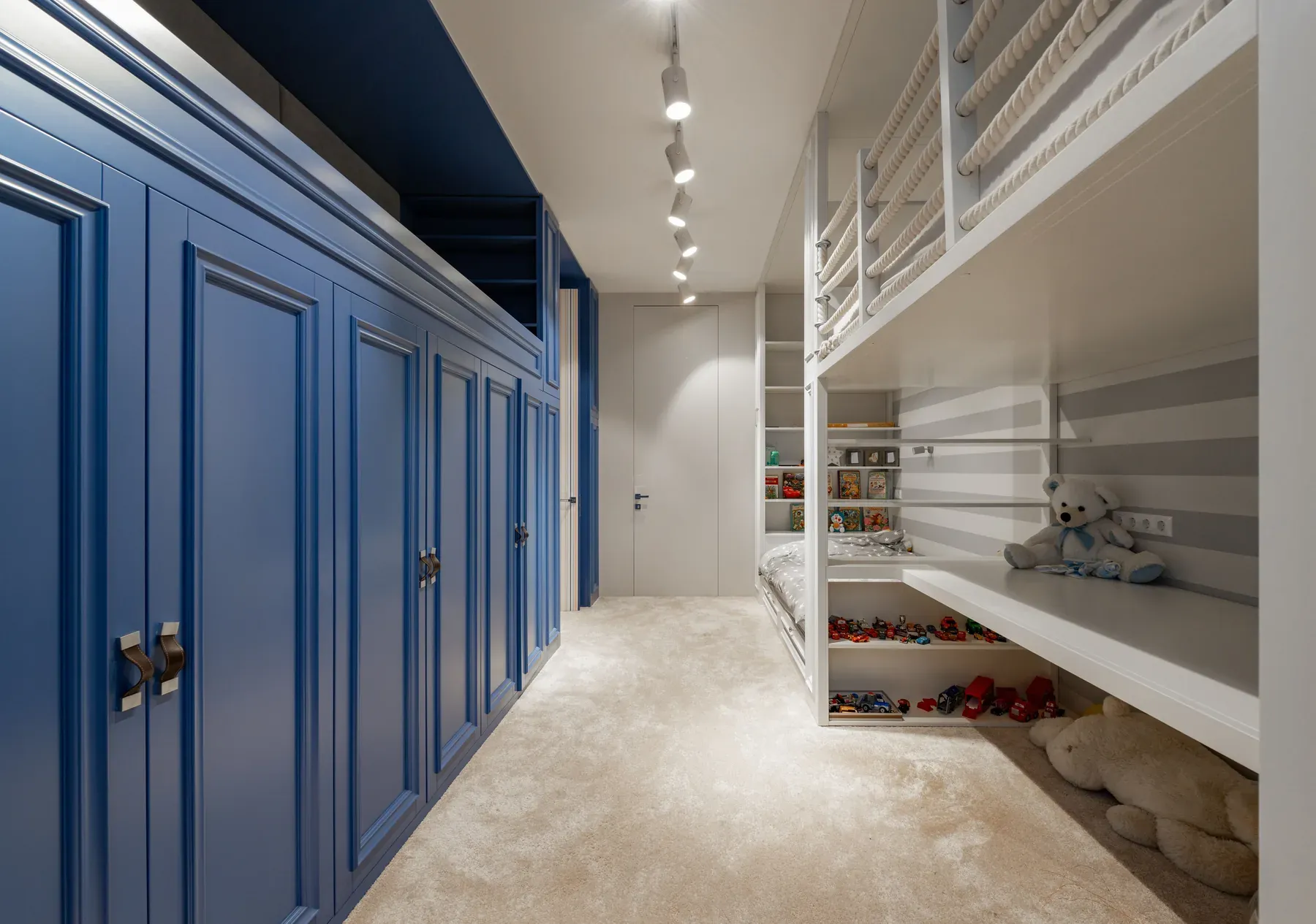Built-in bunk beds with blue storage cupboards — reference image for the TITLI fitted bunk & storage wall