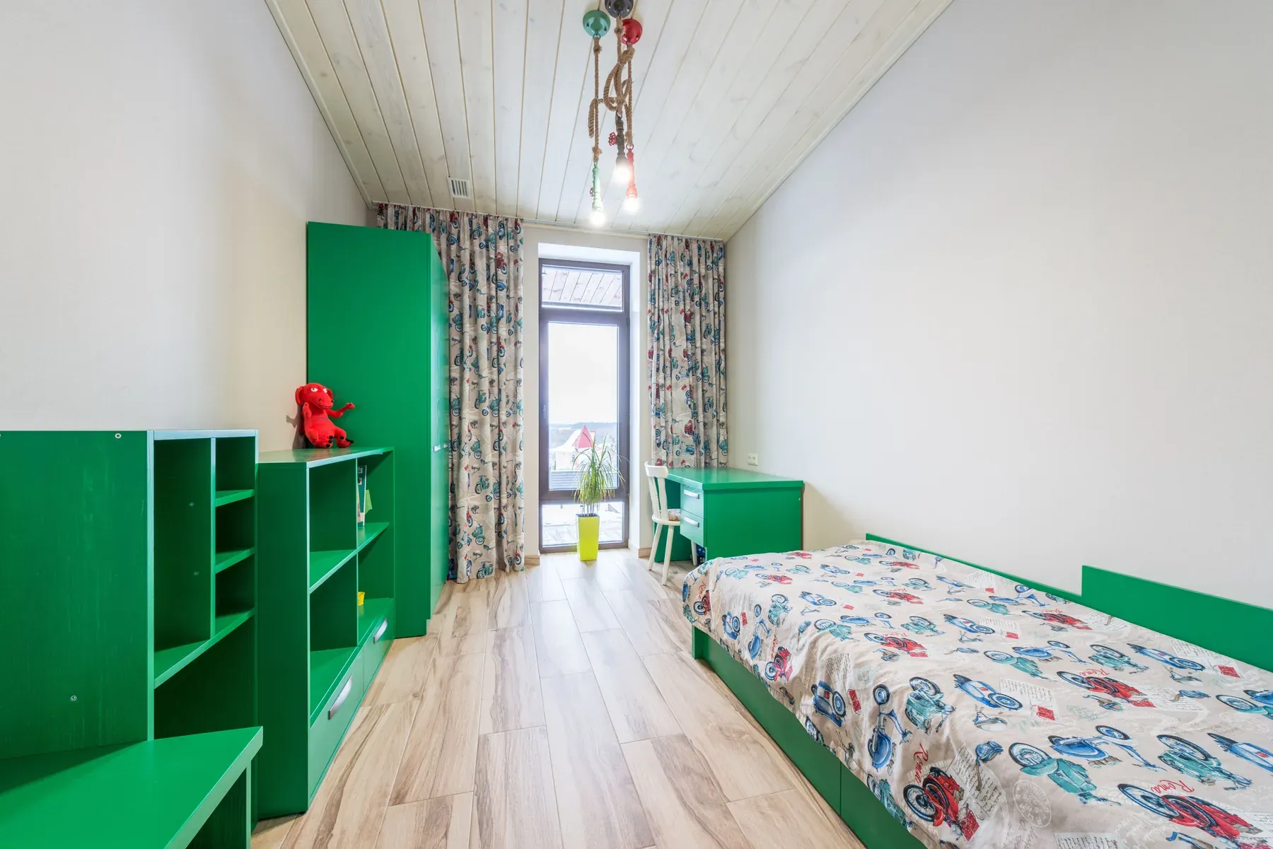 Green kids bedroom with low bed and storage shelves — reference image for the SITARA fitted kids room scheme