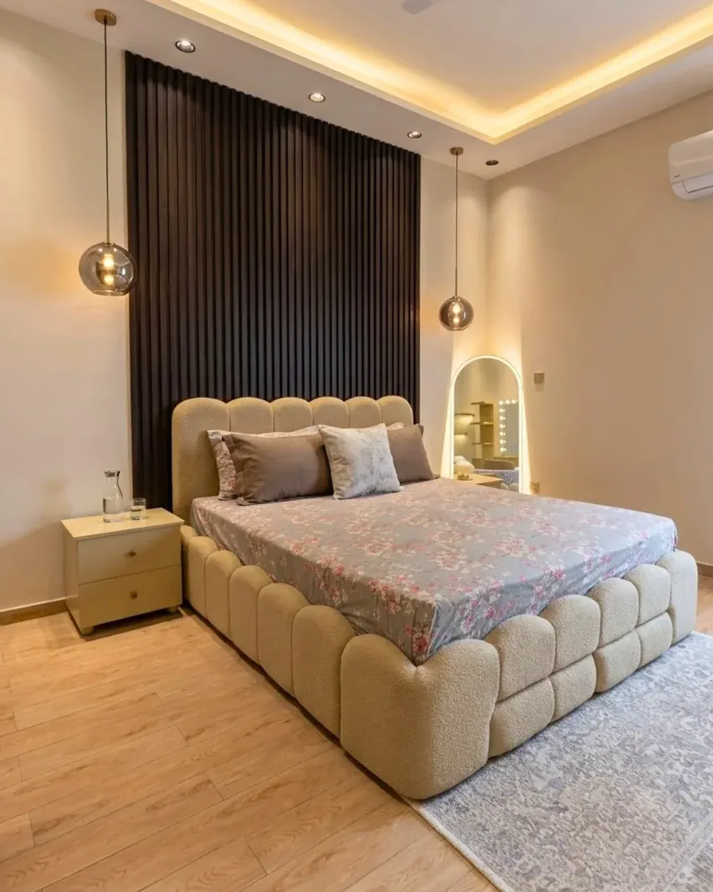 LEHAR Boucle Bed with Side Tables in beige and cream, angled view in a bedroom with ceiling lighting