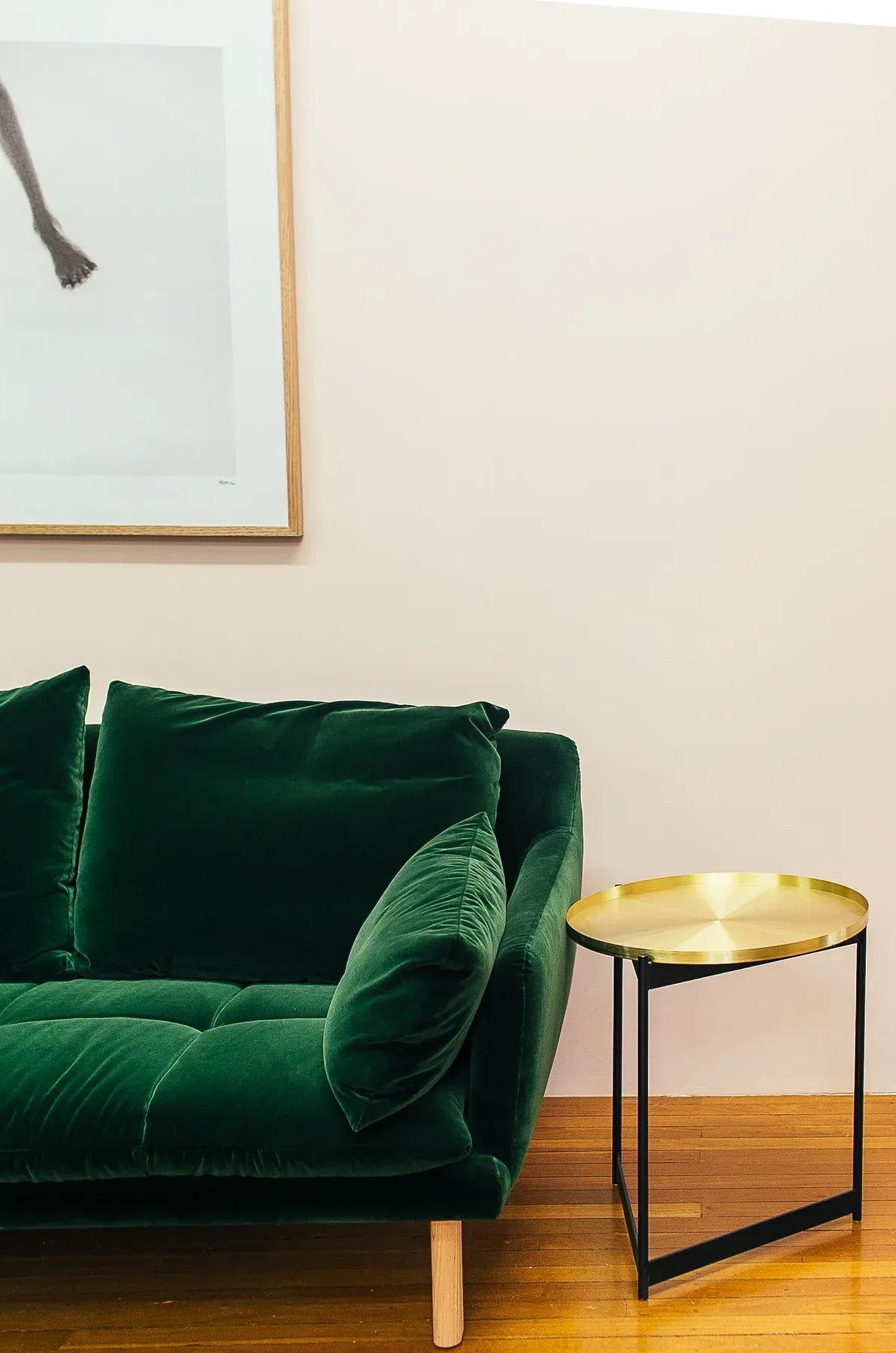 Green velvet sofa with a small round side table — reference image for the MEHFIL velvet two-seat sofa