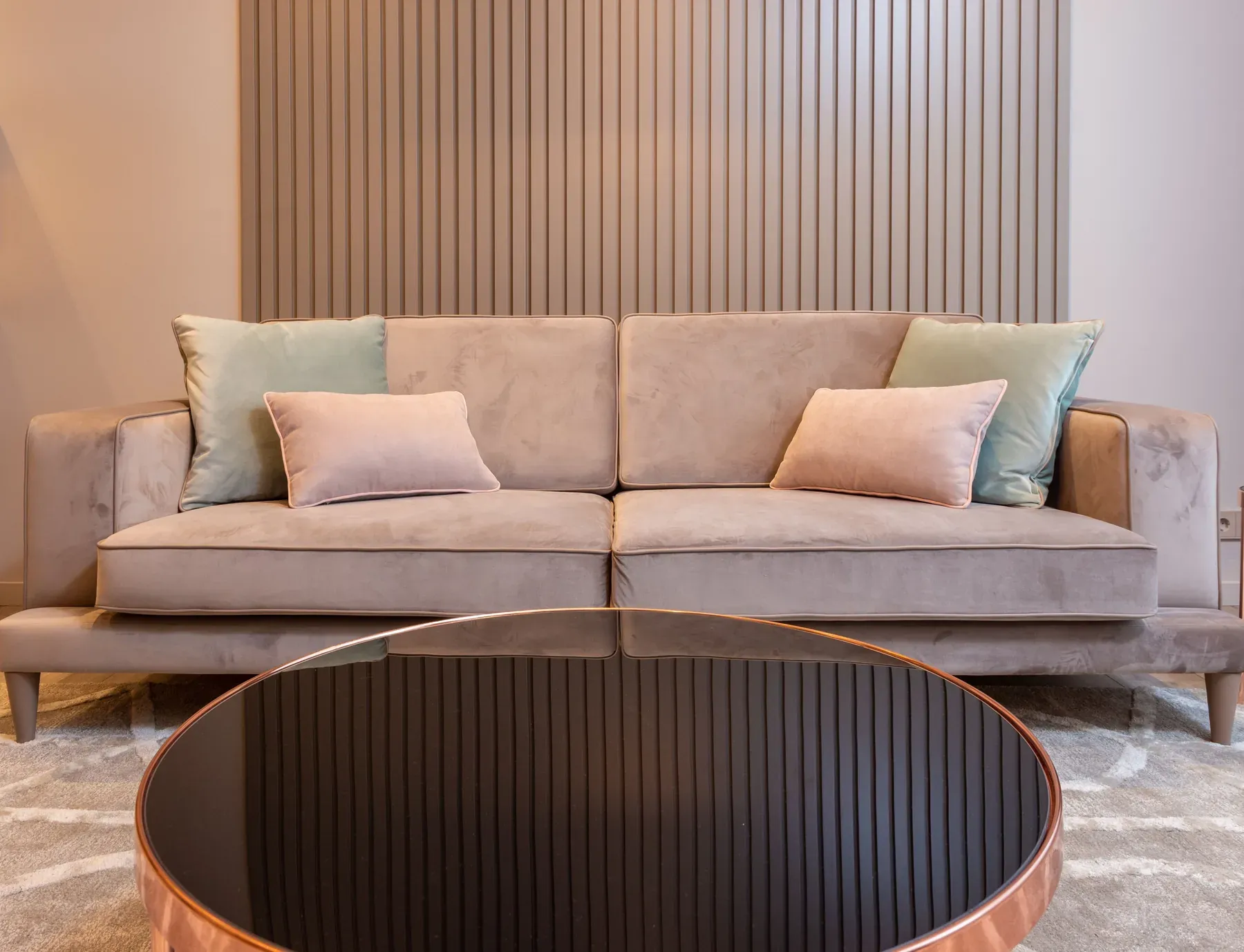 Beige sofa with a dark round coffee table — reference image for the RAAHAT low-back fabric sofa