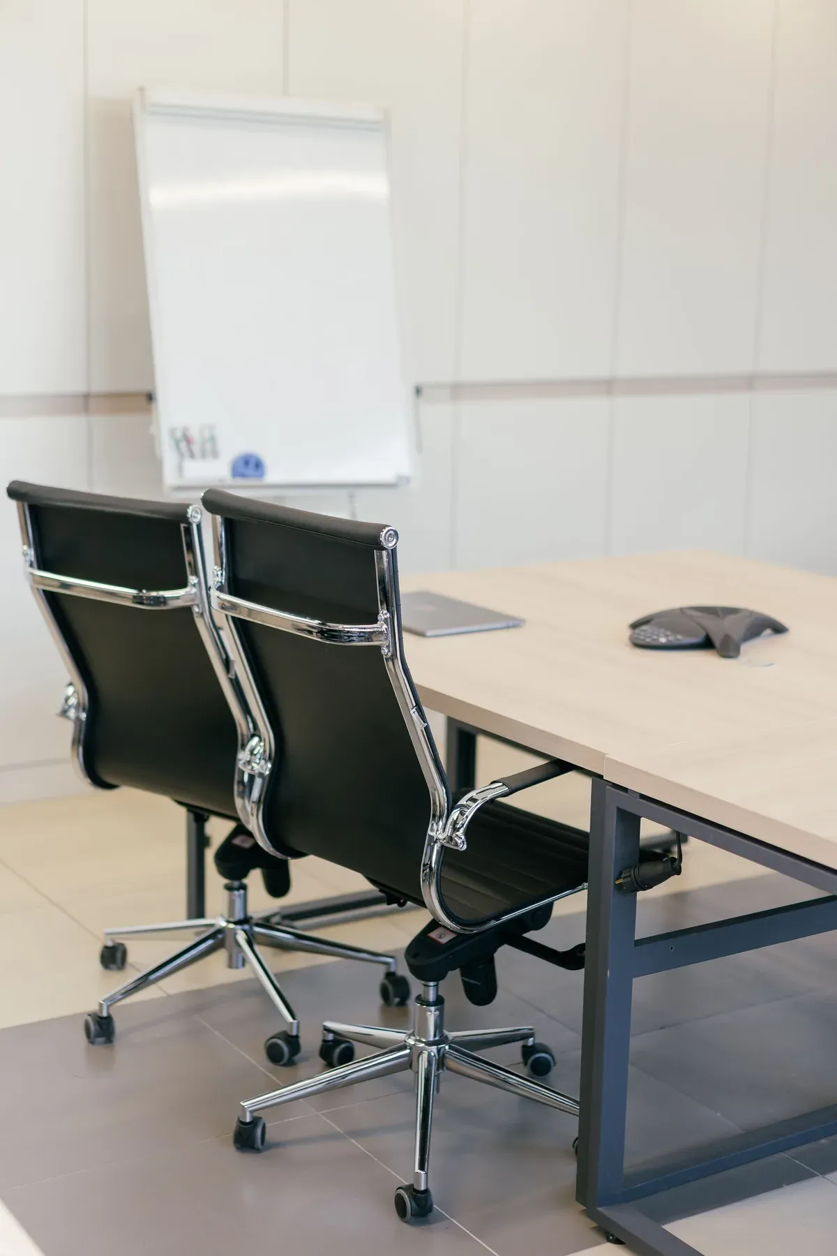 Meeting table with black leather office chairs — reference image for the TAMEER boardroom table & chairs