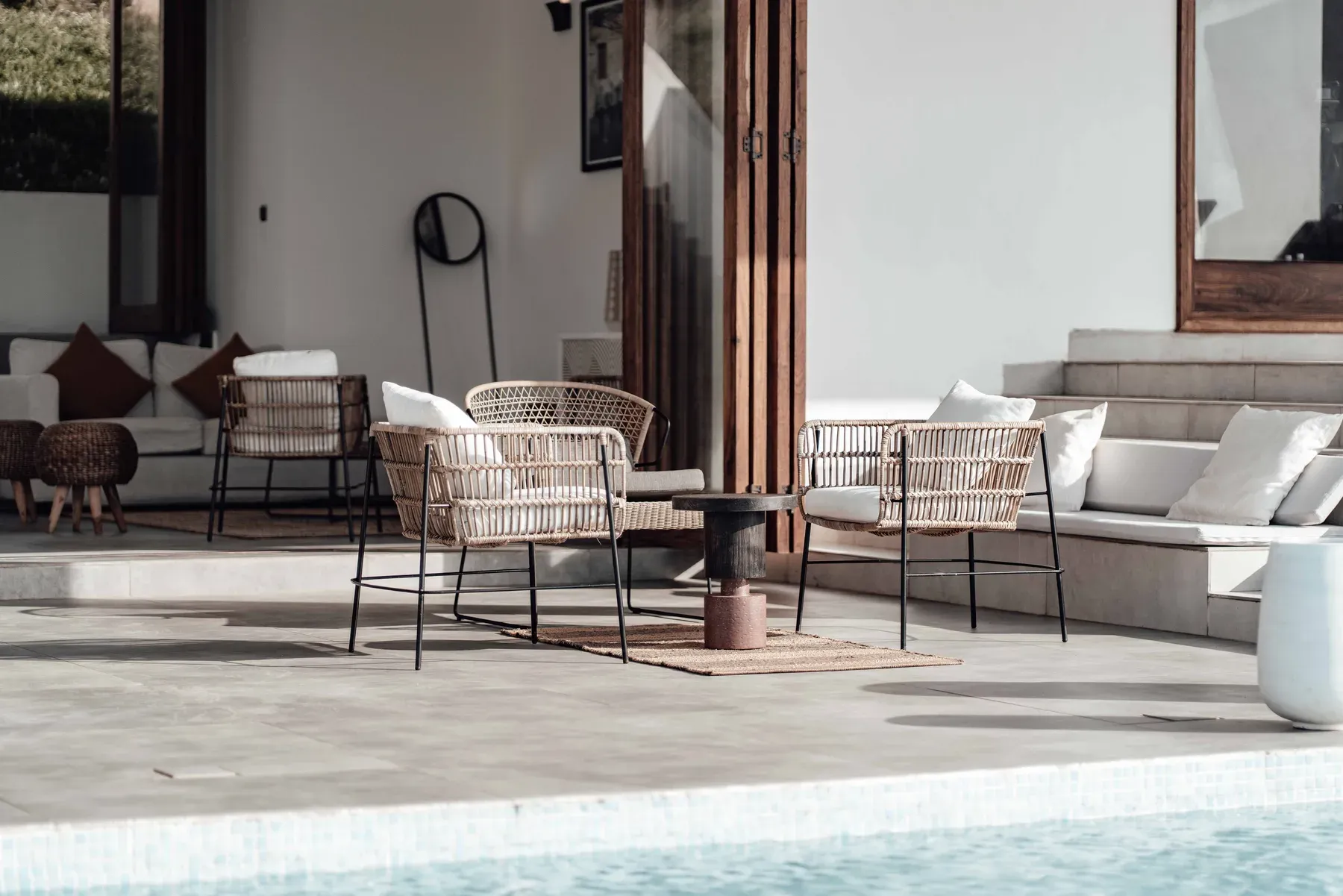 Rattan patio chairs around a small outdoor table — reference image for the SEHAN rattan patio seating set