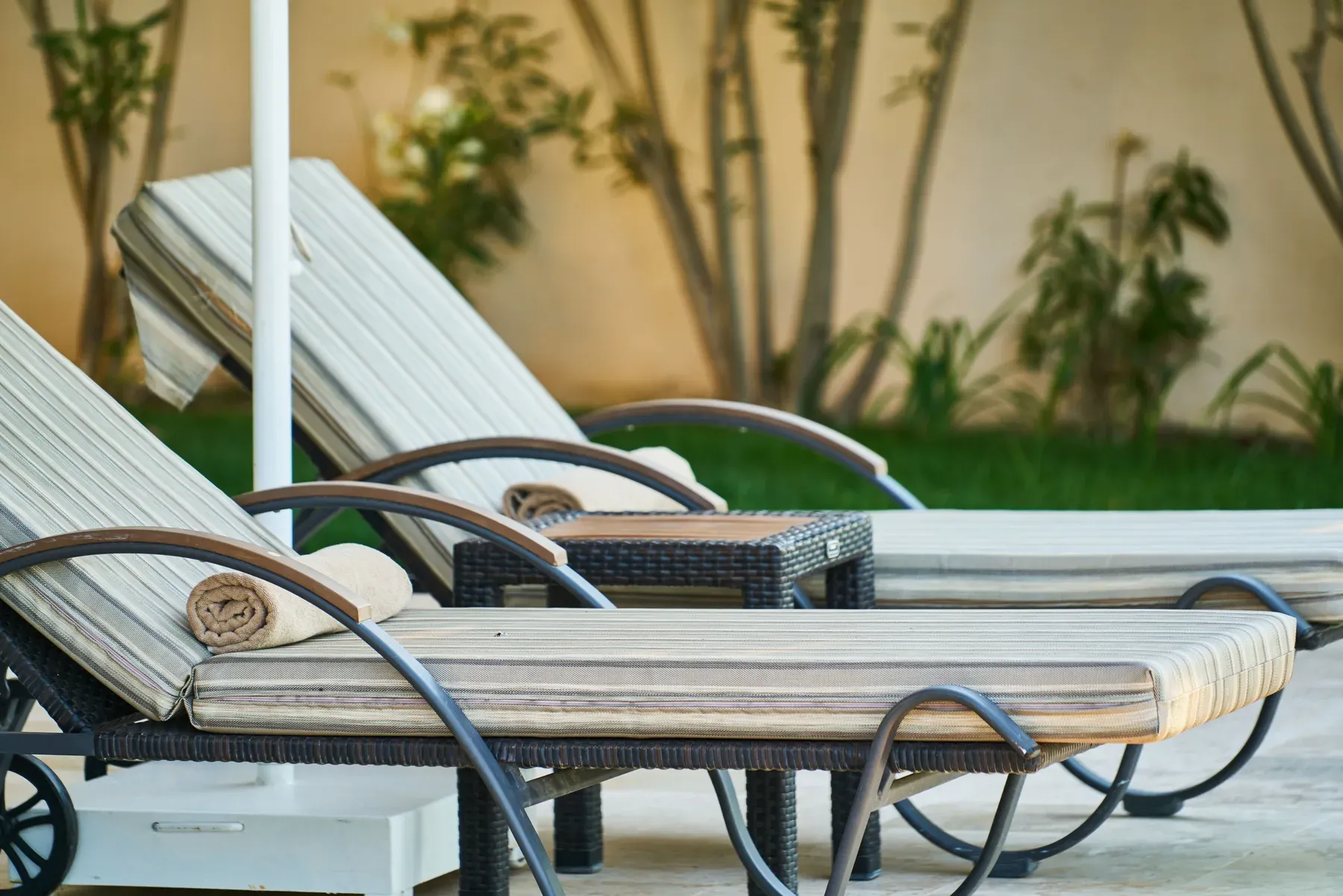 Poolside woven sun loungers with cushions — reference image for the DHOOP poolside sun lounger