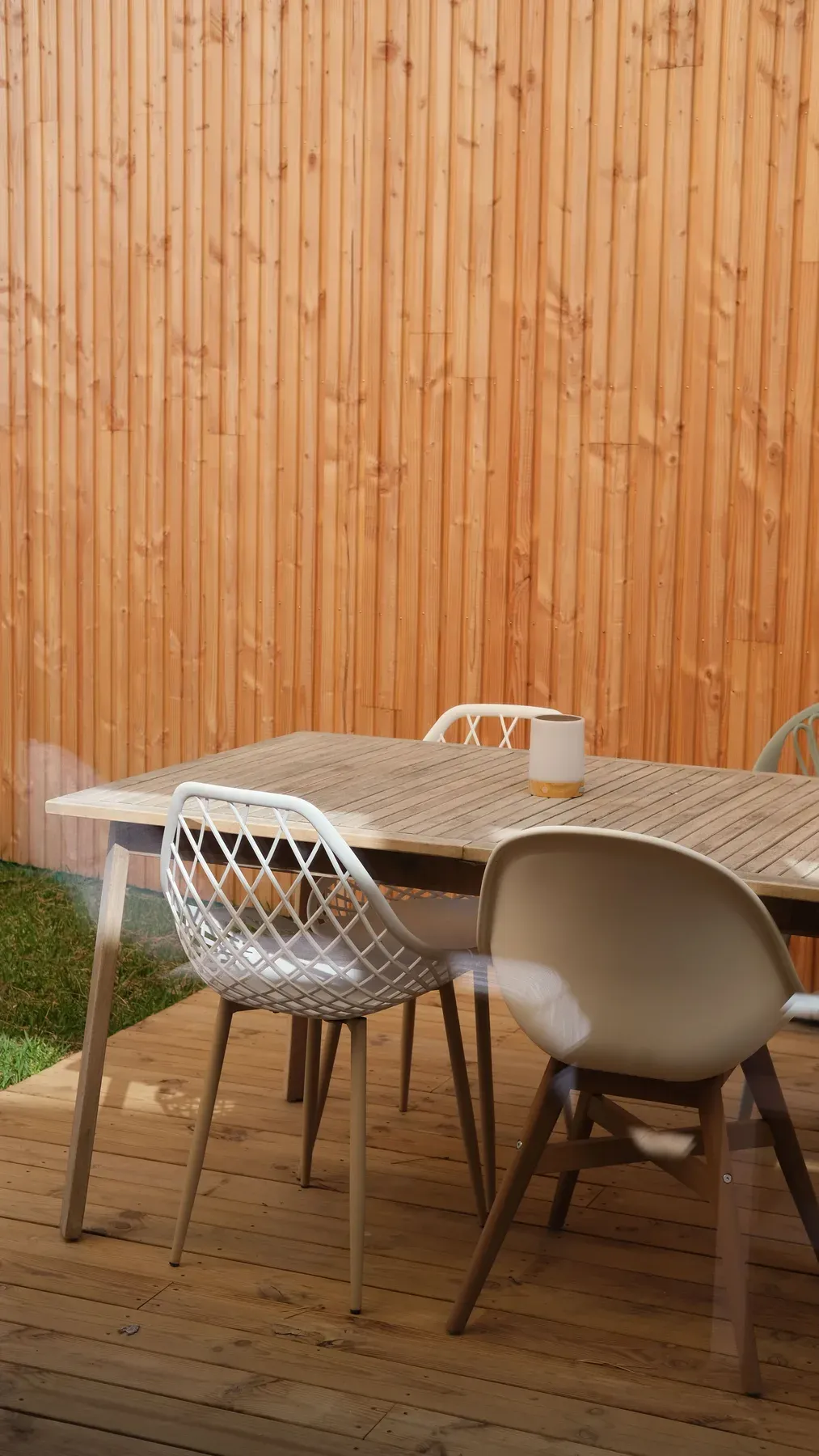 Outdoor deck dining table with mixed modern chairs — reference image for the SABZA deck dining set