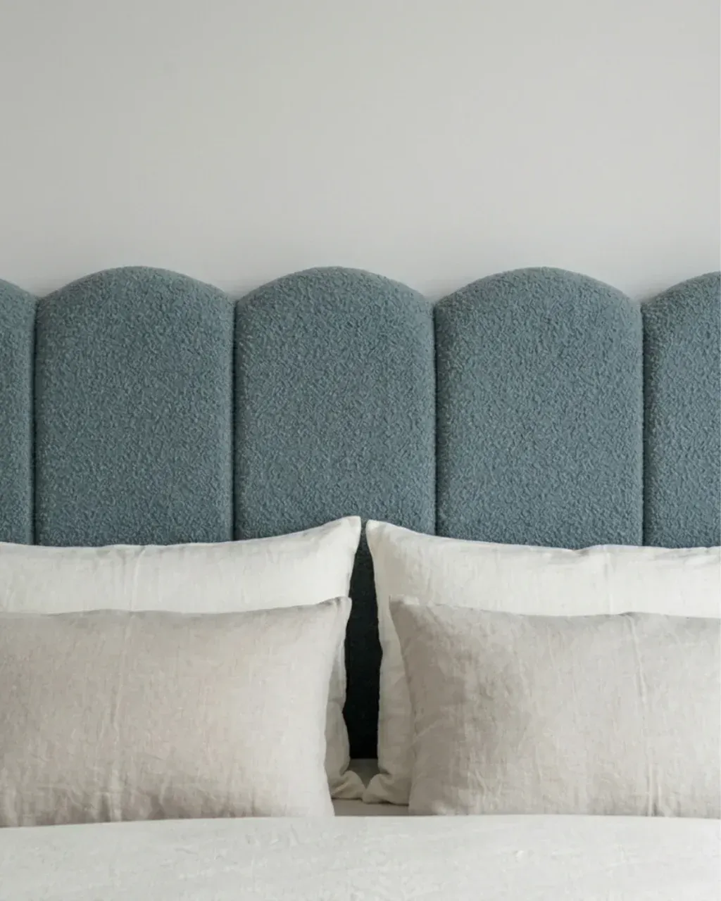 SAVERA Boucle Bed, close view of the scalloped headboard and pillows